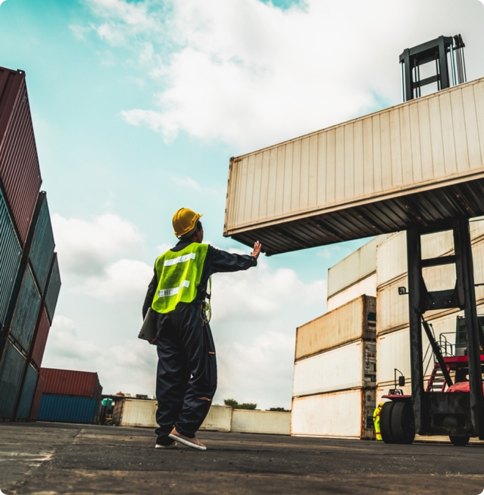 Warehouse worker guiding a shipping container
